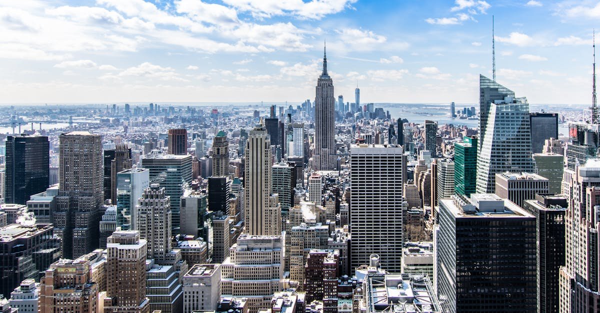 New York USA A stunning aerial view of New York City's skyline featuring the iconic Empire State Building under a bright blue sky.